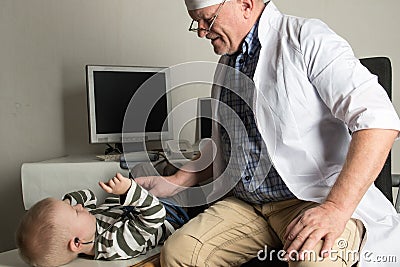 The child doctor examines the patients in his office. Happy children are very fond of a good pediatrician. The concept of a home d Stock Photo