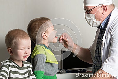 The child doctor examines the patients in his office. Happy children are very fond of a good pediatrician. The concept of a home d Stock Photo