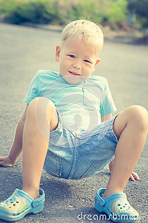 Child doing exercises outdoor Stock Photo