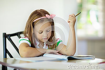 Child doing homework. Kids read and write. Stock Photo