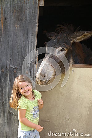 Child and donkey Stock Photo