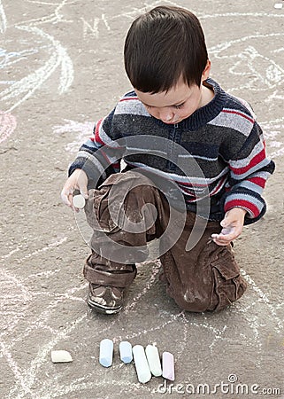 Child drawing with chalk Stock Photo