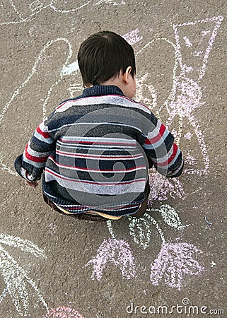 Child drawing with chalk Stock Photo