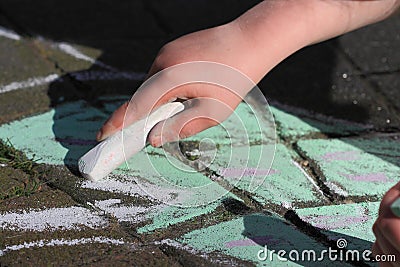 Child drawing with chalk Stock Photo