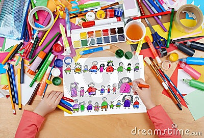 Child drawing cute happy cartoon people in row, top view hands with pencil painting picture on paper, artwork workplace Stock Photo