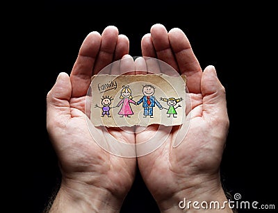 Child drawing of family with the protection of cupped hands Stock Photo