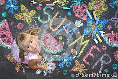 Child drawing summer spirit on asphalt Stock Photo