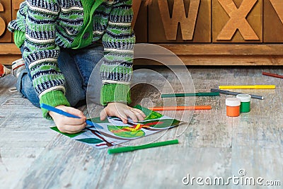 Child draws with markers and pencils drawing Stock Photo