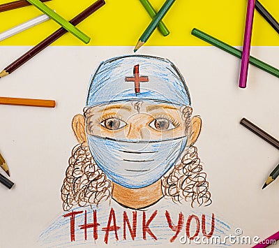 The child draws pencils of a medical worker and the inscription thank you Stock Photo