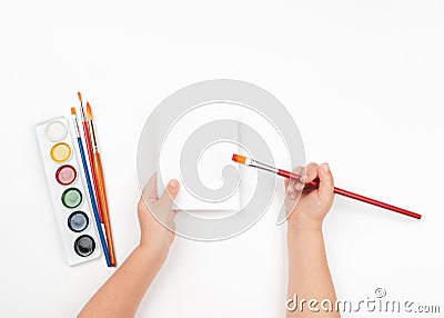 Child draws watercolors on blank sheet Stock Photo