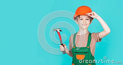 Child dressed as a workman builder. little boy wearing helmet. Portrait little builder in hardhats hammer. Child Stock Photo