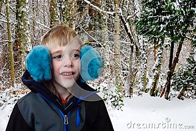 Child dressed for winter in earmuffs Stock Photo