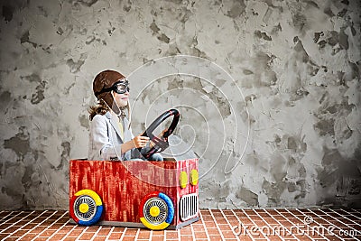 Child driving in a car made of cardboard box Stock Photo