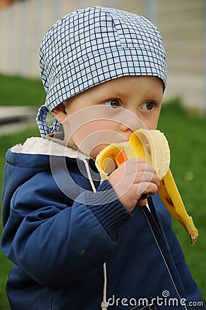 Child eating banana Stock Photo