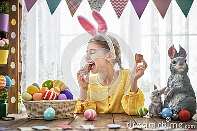 Child is eating chocolate eggs Stock Photo