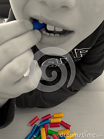 Child eating colourful sweets Editorial Stock Photo