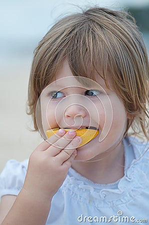 Child eating fruit Stock Photo