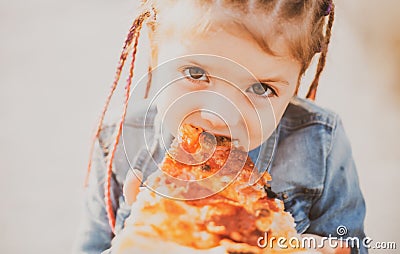 Child eating pizza. Fastfood for kids. Junkfood addiction. Italian cuisine. Children food. Childhood obesity. Tasty food Stock Photo