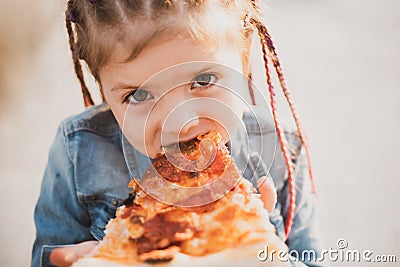 Child eating pizza. Fastfood for kids. Junkfood addiction. Italian cuisine. Children food. Childhood obesity. Tasty food Stock Photo