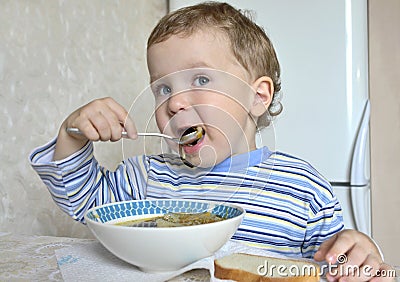 Child eating soup Stock Photo