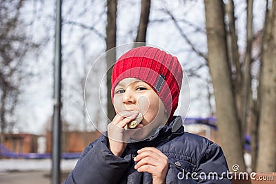 The child is eating the sweetness in the Playground. emotional close-up portrait. Stock Photo