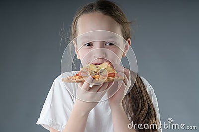 The child is eating pizza. Stock Photo