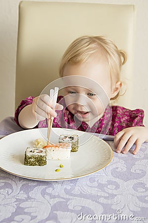 Child eats sushi, rolls, Stock Photo