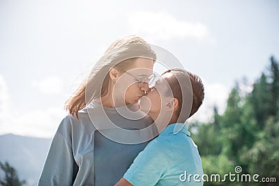 A child embraces mom in the mountain trip Stock Photo