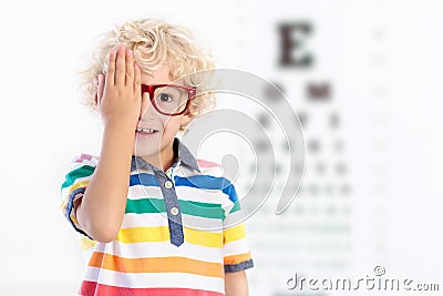 Child at eye sight test. Kid at optitian. Eyewear for kids. Stock Photo