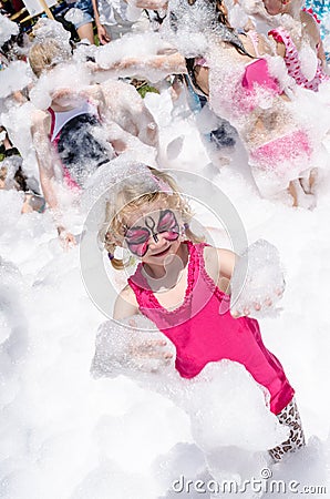 Child with face painting and foam party Stock Photo
