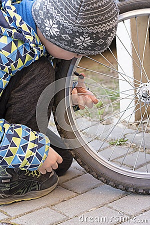 Child fixing bike or bicycle Stock Photo