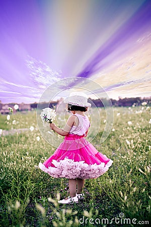 Child in a flower field Stock Photo