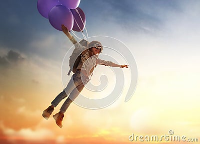 Child flying on balloons Stock Photo