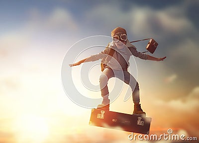 Child flying on a suitcase Stock Photo