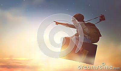 Child flying on a suitcase Stock Photo