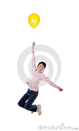 Child flying with yellow balloon Stock Photo