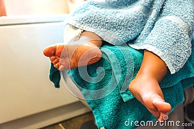 Child fresh from bath with towel and foot wrinkled by water Stock Photo