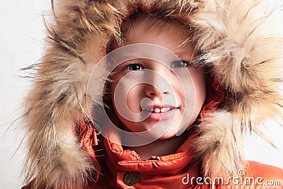 Child in fur hood and orange winter jacket. fashion kid.children.close-up Stock Photo