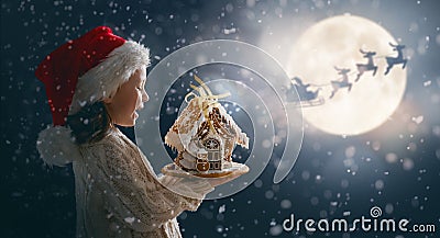 Child with gingerbread house Stock Photo