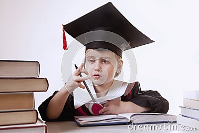 Child girl college graduate thinking about her perspectiv and future job. Humorous photo. (Knowledge, studies, work, career Stock Photo