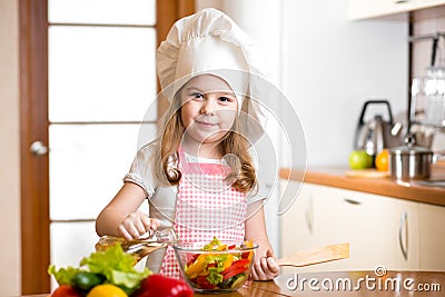 Child girl cooking at kitchen Stock Photo