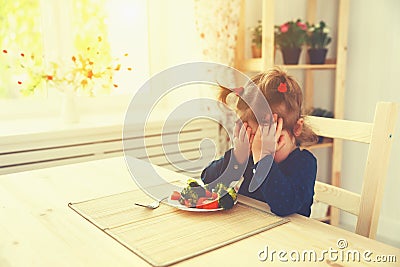 Child girl does not like and not want to eat vegetables Stock Photo