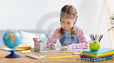 Child girl doing homework writing and reading at home Stock Photo