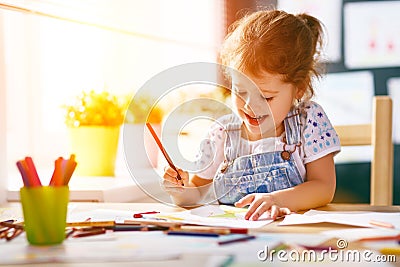 Child girl draws with colored pencils Stock Photo