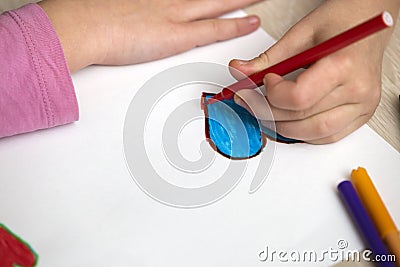 Child girl hands drawing with colorful pencils crayons heart on white paper. Art education, creativity concept Stock Photo