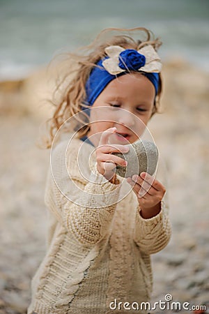 Child girl holding stone with focus on hands Stock Photo