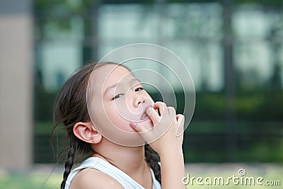 Child girl intend sucking her fingers Stock Photo