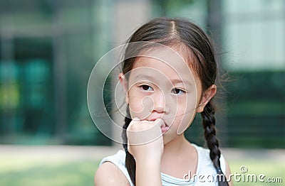 Child girl intend sucking her fingers. The gestures of children who lack confidence Stock Photo