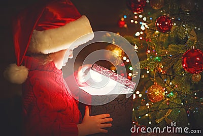 Child girl with a magic Christmas gift Stock Photo