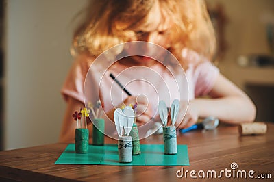 Child girl making easter craft tic tac toe game at home Stock Photo